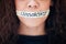 Censorship is cowardice. Closeup shot of an unrecognisable woman with tape on her mouth that has the word censorship