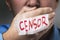 Censorship in society. The man closed his mouth with his hand. Inscription censor