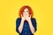 Censorship. Speak no evil concept. Concerned scared redhead woman curly afro hair covering her mouth with hands in blue jeans
