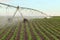 A center pivot sprinkler irrigating farmland.