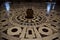 At the center of various circles there is a large vase, a detail of the inlaid floor of the Cathedral of Santa Maria del Fiore.
