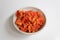 Centered bowl of cinnabar red chanterelle mushrooms on white background