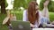 Centered young woman studying with laptop in park on a nice day