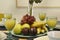 Centerpiece with a tray of fresh fruit and glasses