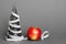 A centimeter-long ribbon is wrapped around a small toy Christmas tree next to a ripe apple. The concept of healthy and healthy