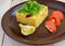 Central Asian traditional dish - pilaf (plov risotto) in the form of a square, decorated with chopped parsley