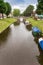 Central canal with boats leading to the old stone bridge in Friedrichstadt