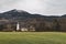 Central European country side autumn dramatic scenic view with field church and monastery buildings on Alps mountains background