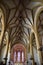 Central nave with beautiful ribs and three slender windows behind the altar of a parish church in Graz.