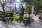 Central Square of Archanes village with the traditional coffee shops. Bronze statue of a cretan hero