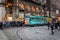 Central street of Milan with many people near tram station, located near Piazza Del Duomo, Italy