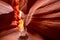 Centuries-old colorful sandstones stacked in layered fire waves in a narrow sandy labyrinth in Lower Antelope Canyon in Page