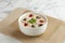 Century Egg with Minced Pork Congee served in a bowl isolated on mat side view on grey marble background