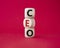 CEO - hief executive officer symbol. Concept word CEO on wooden cubes. Beautiful red background. Business and CEO concept. Copy