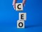 CEO - hief executive officer symbol. Concept word CEO on wooden cubes. Businessman hand. Beautiful blue background. Business and
