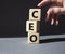 CEO - hief executive officer symbol. Concept word CEO on wooden cubes. Businessman hand. Beautiful grey background. Business and