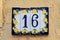 Ceramic background. Italian traditional patterns on tiles, handmade craft painting - numbers for apartments and houses. Number