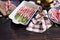 ceramic baking dish with aspargus covered with bacon on wooden kitchen table