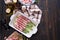 ceramic baking dish with aspargus covered with bacon on wooden kitchen table