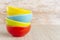 Ceramic bowl assorted colors on wooden background