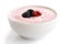 Ceramic bowl of fruit yoghurt with berries isolated on white background.