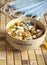 A ceramic bowl with the inscription breakfast, full of various tablets and capsules, stands on the countertop.