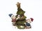 Ceramic Christmas statuette green Christmas tree with children on a white background. isolate