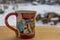 Ceramic color cup with animals collage and snowy background