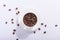 Ceramic cup with coffee beans, on a white background. The harsh shade of the sun, the art concept of the morning and the charge of