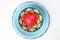 ceramic decorated food bowl blue plate with three dimension 3d red hart symbol inside on white background copy text space top view