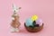 Ceramic figurine of a bunny in a dress and colorful Easter eggs in plate