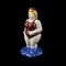 Ceramic figurine of a plump woman in a pin-up swimsuit on a black background.