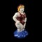 Ceramic figurine of a plump woman in a pin-up swimsuit on a black background.