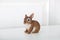 Ceramic figurine of rabbit  Isolated on white background. Close-up of brown statuette of an Easter bunny. Porcelain bunnie. Easter