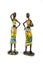 Ceramic figurines. Two African American women painted in bright national outfits Isolated on white background.