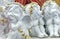 Ceramic figurines of white angels with golden wreaths
