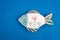 Ceramic fish handmade. On a blue background. Handwork, hobbies, crafts