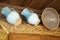 Ceramic glazed blue jugs and traditional clay bowl on wooden background