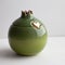 Ceramic green pomegranate or on grey background