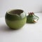 Ceramic green pomegranate or on grey background