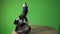 Ceramic holder with smoldering incense cone on top. Heavy backflow smoke fountain on green background. Home decor