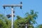 Ceramic insulation for electric cable hanging on the electric pylon with blue sky background.