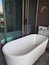 Ceramic large white bathtub on the balcony