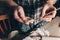 Ceramic master smears a heart cut out of clay with a brush