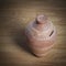 Ceramic money box on a wooden background