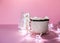 Ceramic mug with hot fresh cocoa drink and handmade funny marshmallow snowman on soft pink background