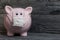 Ceramic piggy bank in pink. With a gauze bandage. Savings on treatment and life during an epidemic
