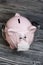 Ceramic piggy bank in pink. With a gauze bandage. Savings on treatment and life during an epidemic