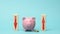 Ceramic pink piggy bank and wooden blocks with red down and fan arrows. The concept of fluctuating bank interest, falling and