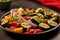 ceramic plate of grilled veggies dusted with seasoning